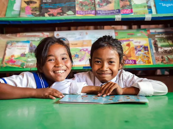 Len Sokha, 10, and her best friend Sok Na in the school library
