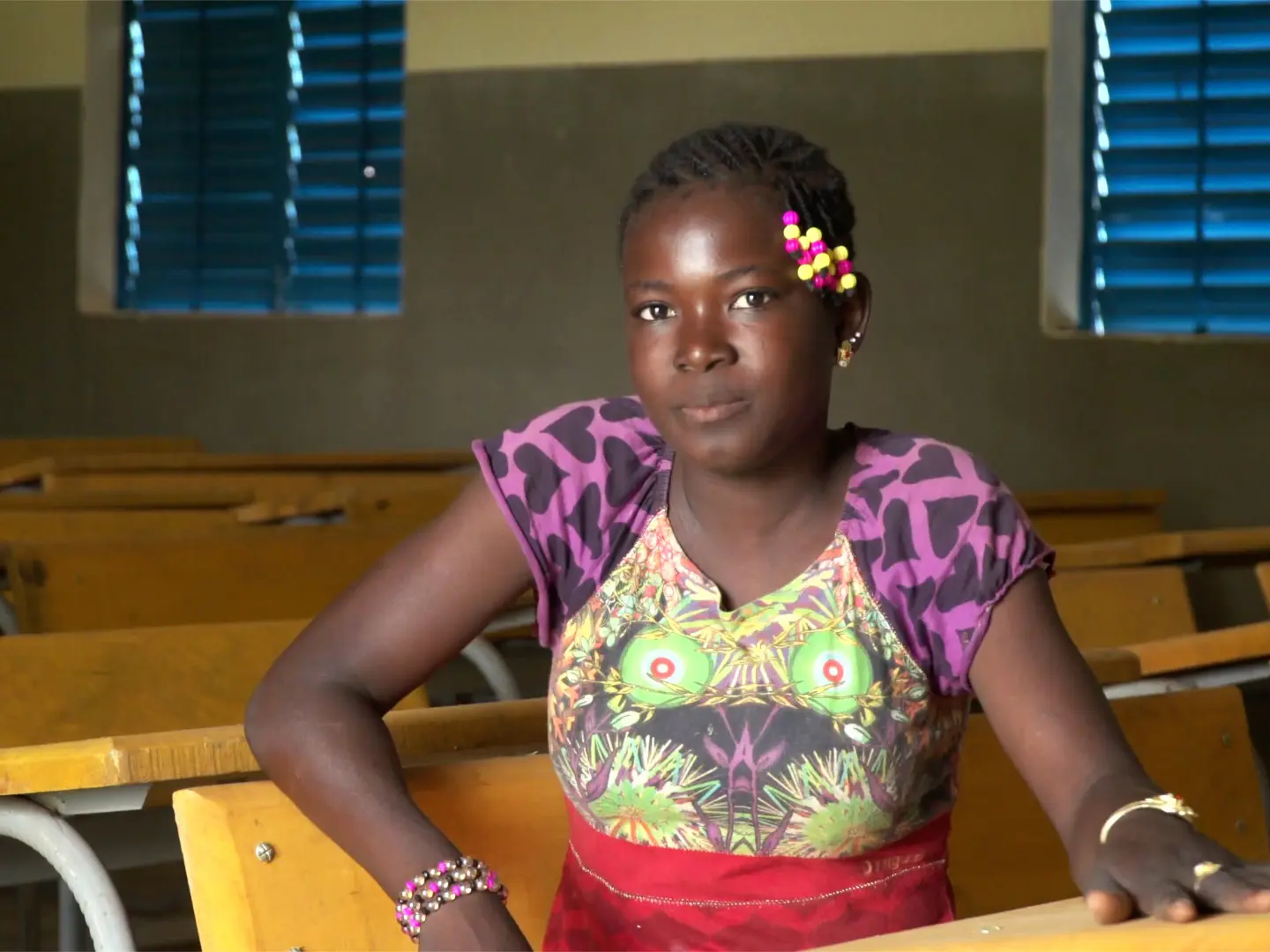 Mariéta, 15, sitting in her school classroom in Burkina Faso.